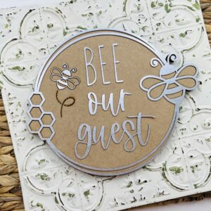 this is a wood and metal bee cutout with small and large embelishments