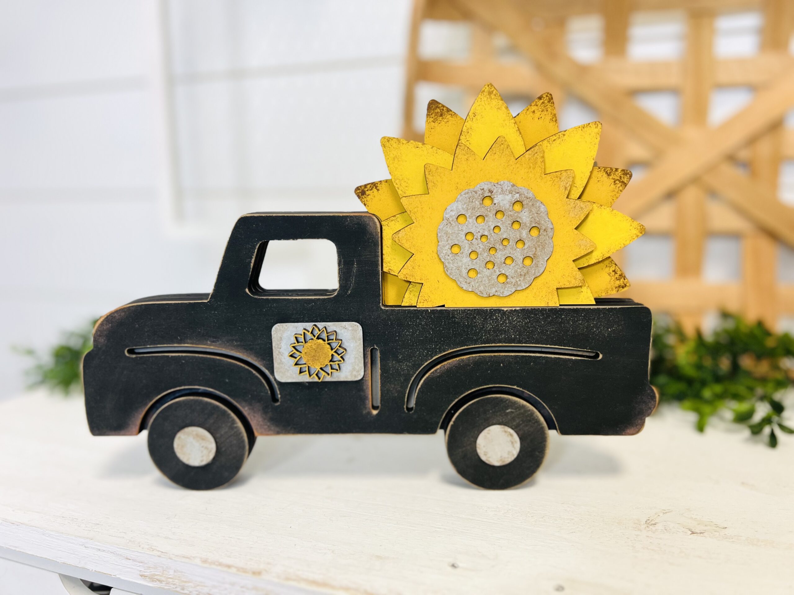 This is a farmhouse truck with an interchangeable sunflower bed for crafting. This is a finished painted variation of the cutout set.