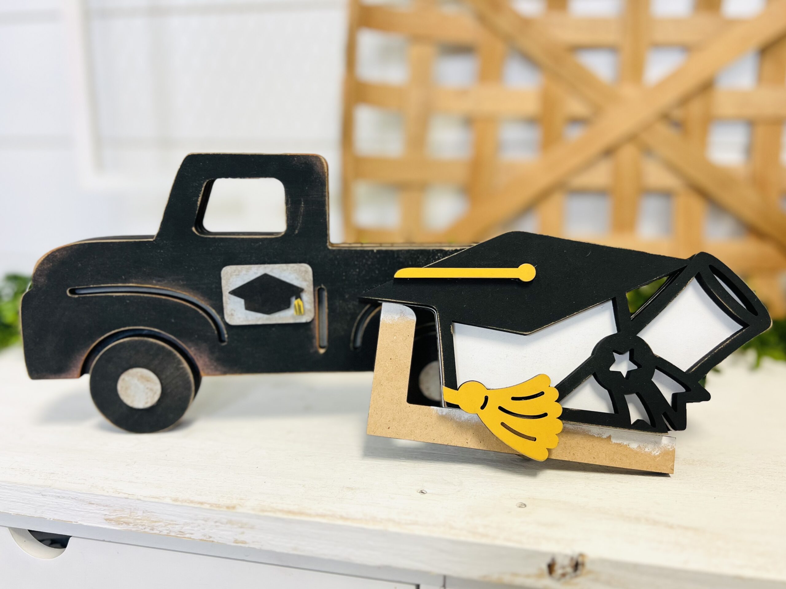 This is a farmhouse truck with an interchangeable graduation hat theme for crafting. This is a finished painted variation of the cutout set.