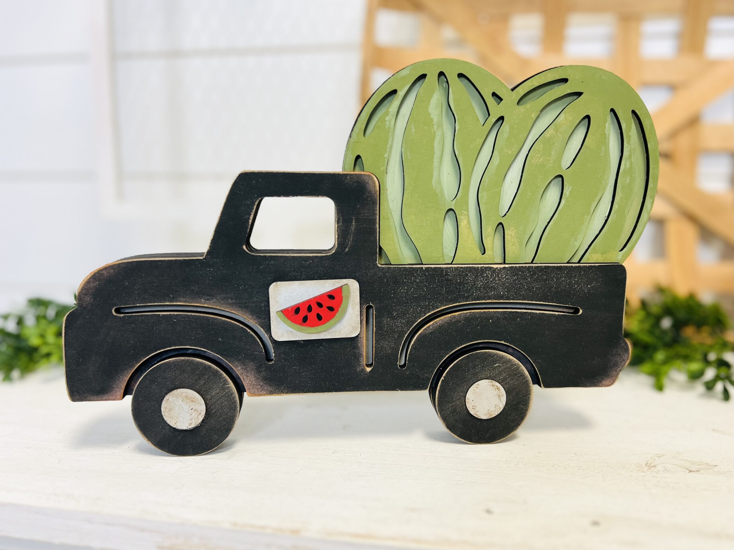This is a farmhouse truck with an interchangeable watermelon set for crafting. This is a finished painted variation of the cutout set.