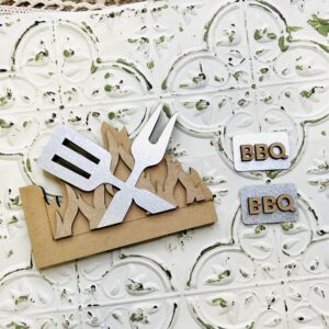 Wood and metal cutouts for crafting and diy projects. These are in the shape of flames and grilling tools.