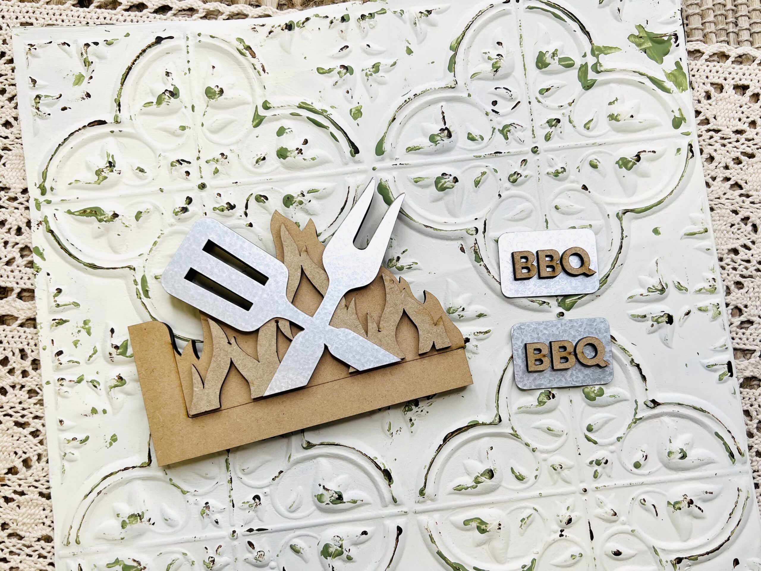 Wood and metal cutouts for crafting and diy projects. These are in the shape of flames and grilling tools.